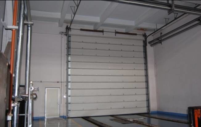 Miglior prezzo stazione antincendio ascensore industriale automatico a forma di magazzino porte sezionali con rilascio di emergenza e design personalizzato per fabbrica